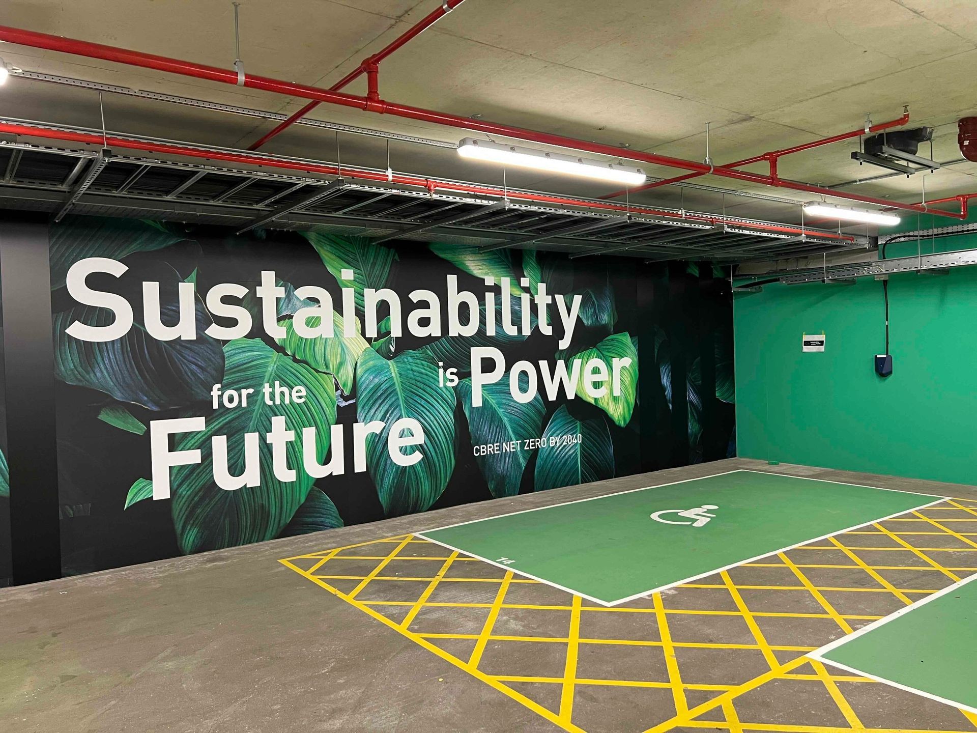 Underground car park with large wall graphic and painted floor bays
