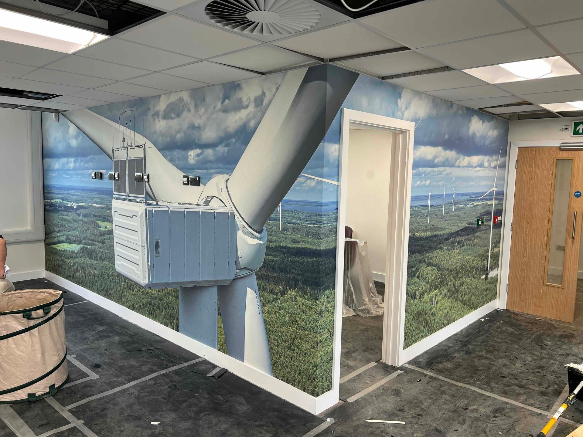 Office wall wrapped in wind turbine landscape wallpaper