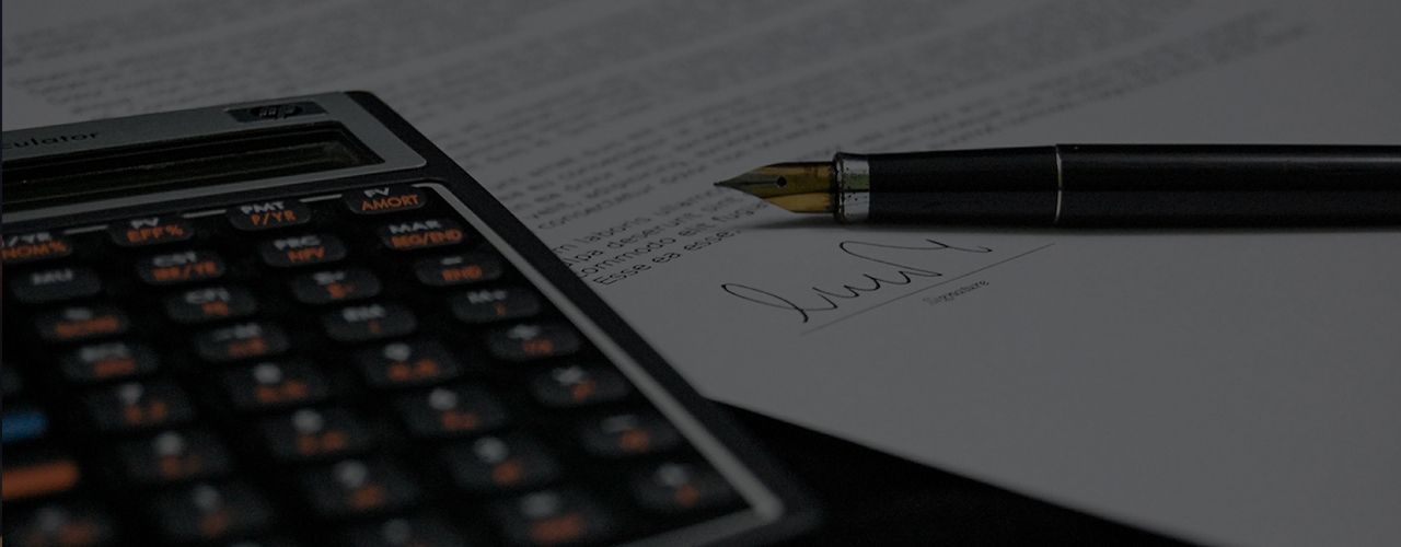 Calculator and Pen — Decatur, GA — DeWoskin Law Firm