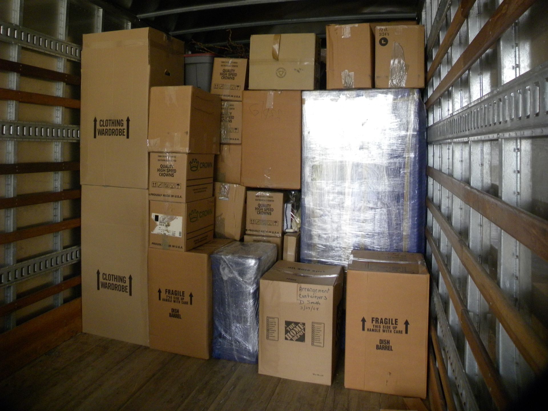 Storage Near You in Jacksonville, FL Boxes and wrapped items stacked inside a moving truck.