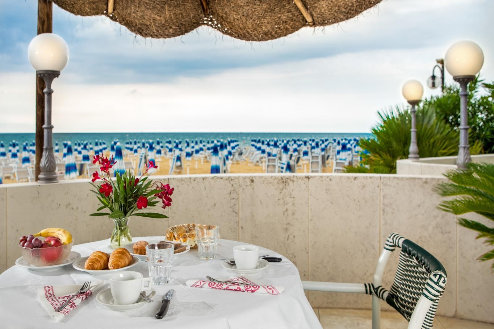 A table with food on it and a view of the sea.