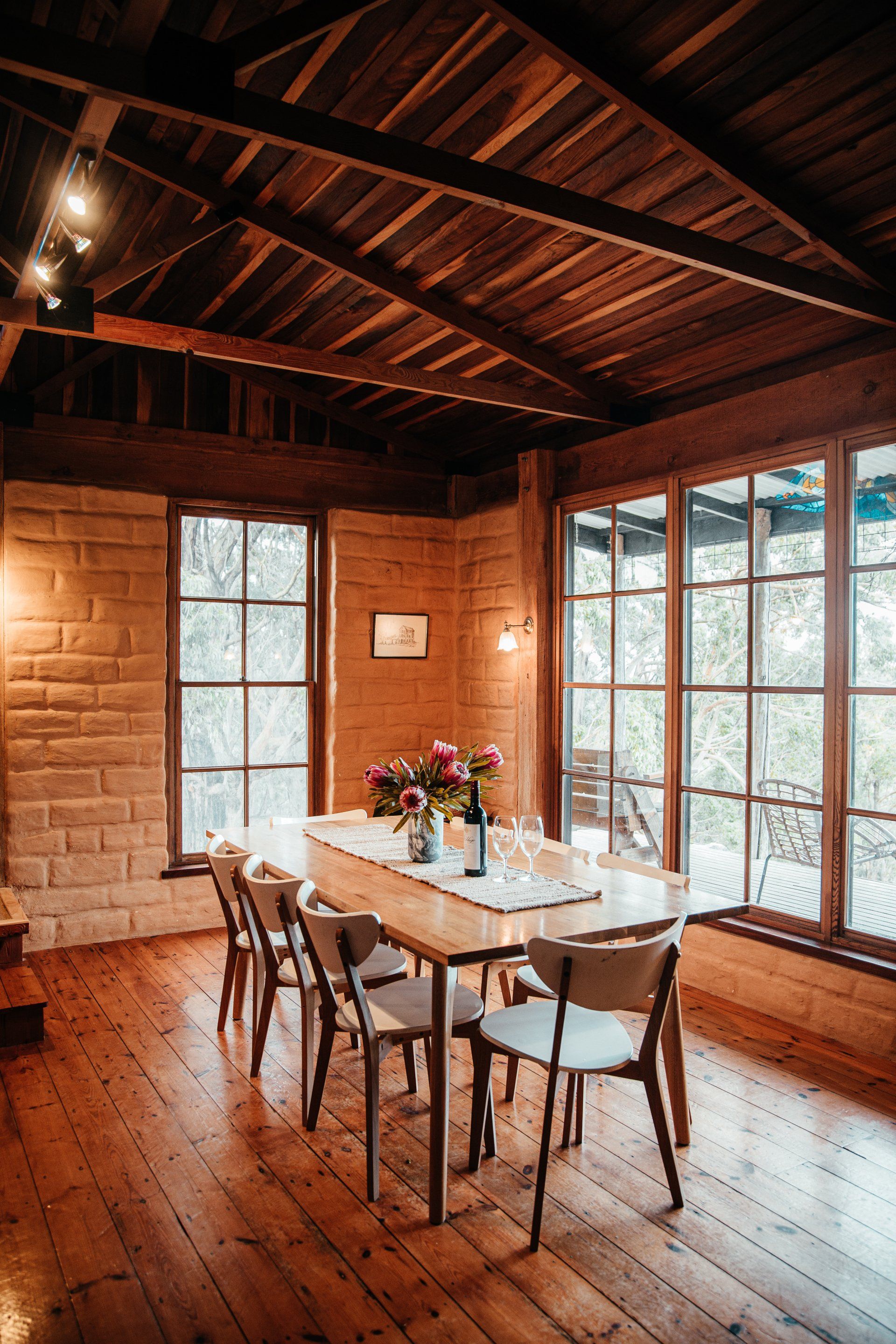 Timber-lined living room with vaulted ceilings and large windows overlooking the Otways