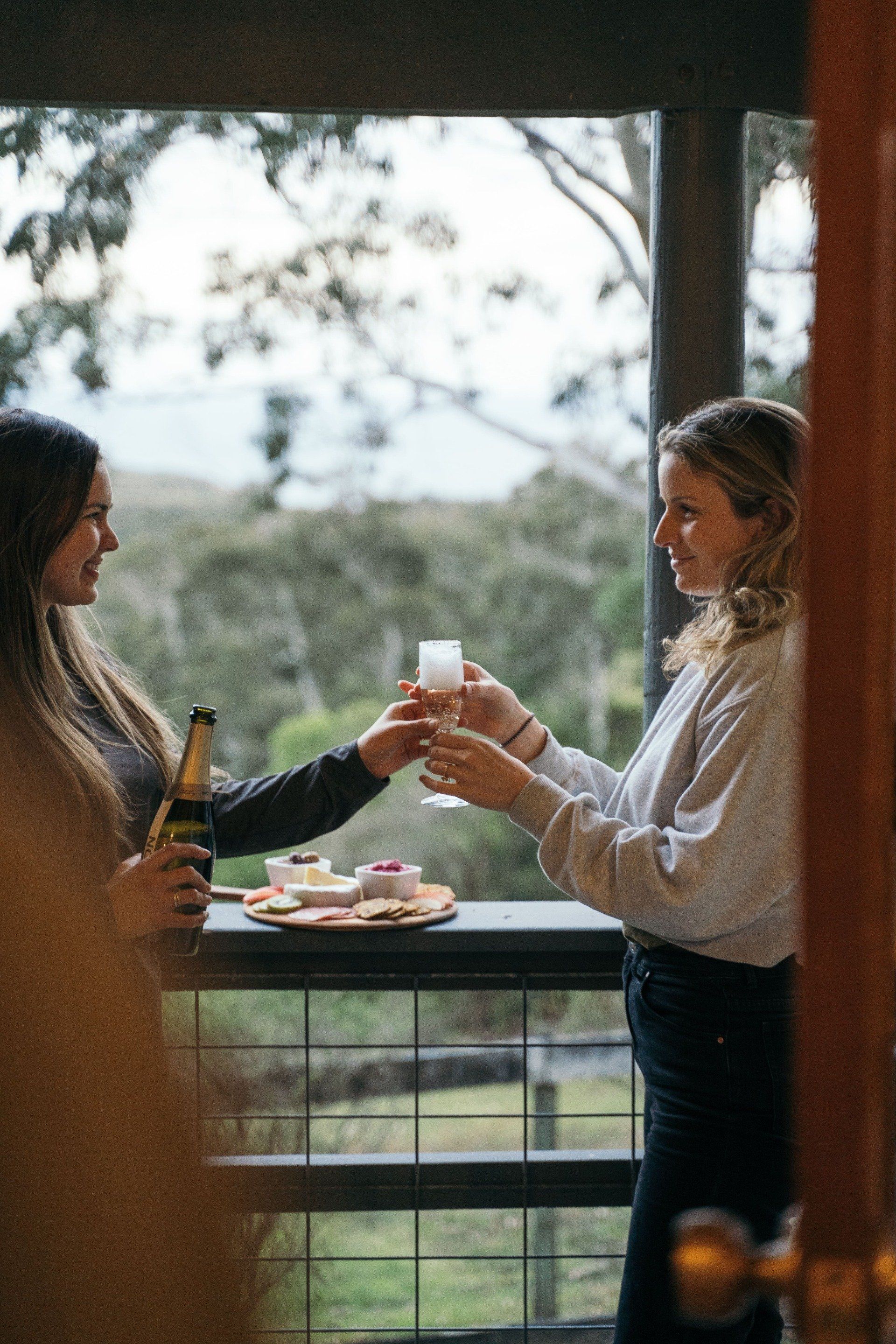 Guests relaxing on the balcony at Cape Cottage