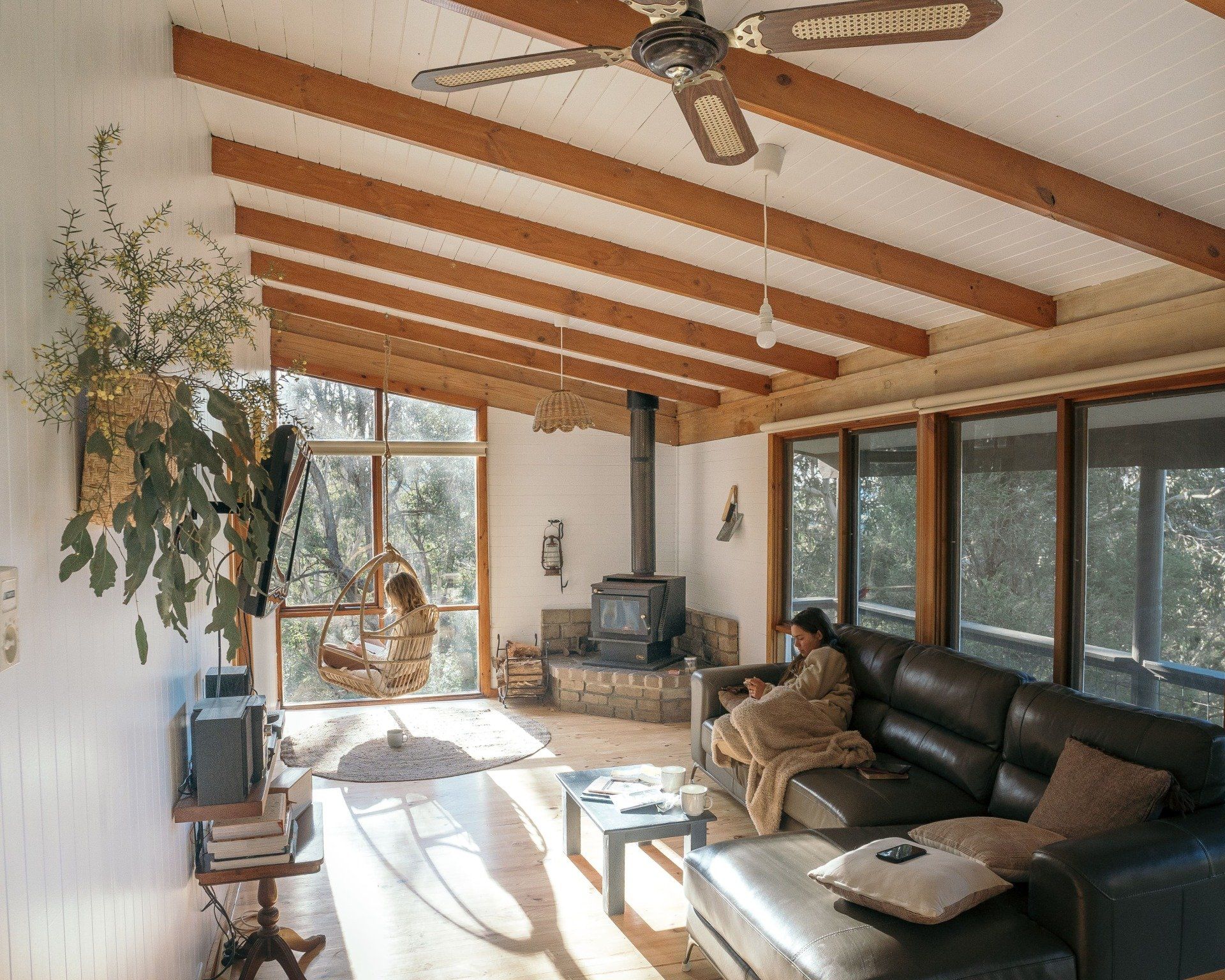 beautiful lounge in cape cottage, reading in a hanging chair.