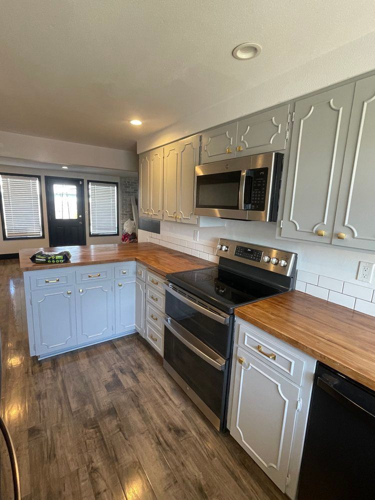 A kitchen with a stove , microwave , and dishwasher.