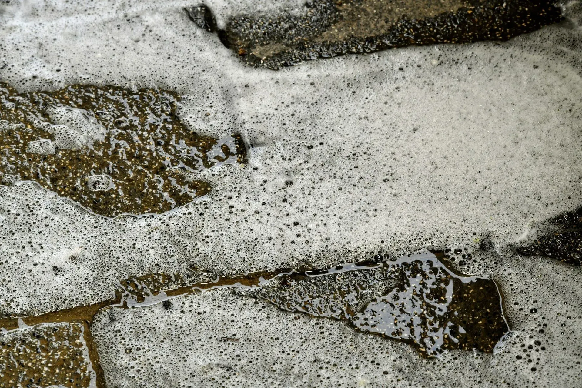 A close up of a brick wall with foam on it A close up of a brick wall with foam on it
