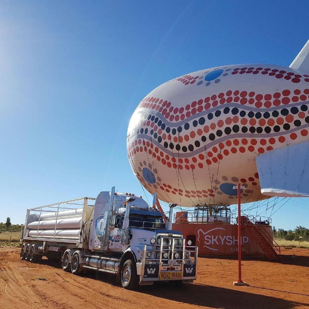 Truck Parked Next to A Large Colorful Airship in A Desert Setting — Central Australian Sidelifter Haulage in Ciccone, NT