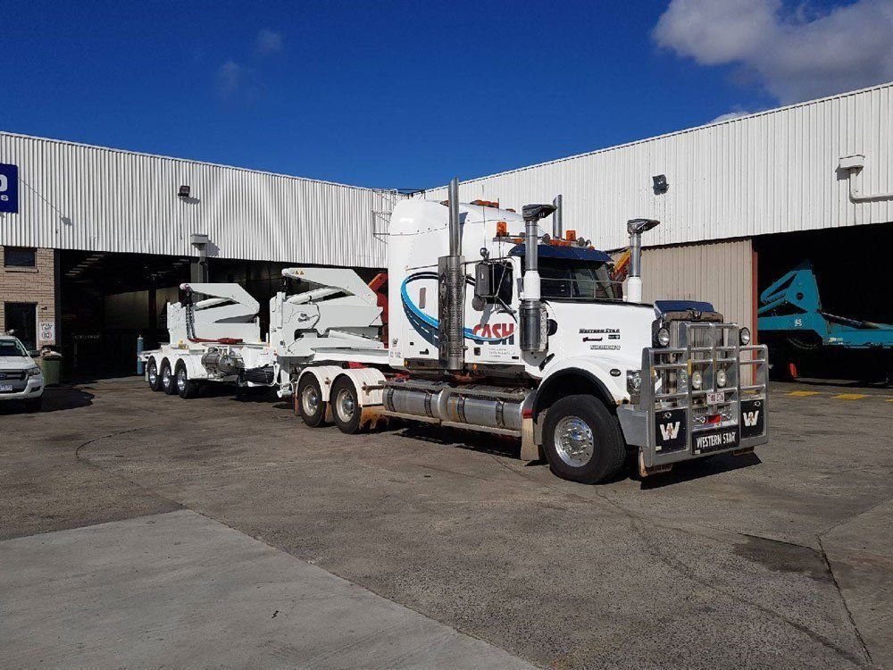 White Semi-Truck with Trailer Parked Outside a Building — Central Australian Sidelifter Haulage in Ciccone, NT