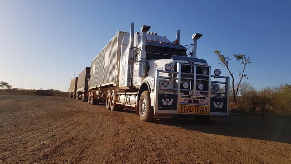 White Semi-Truck with Trailer on A Dirt Road — Central Australian Sidelifter Haulage in Ciccone, NT