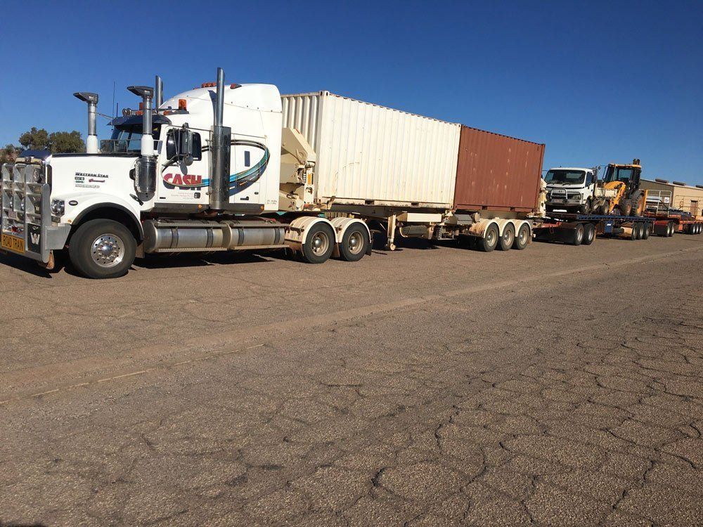 A White Semi-Truck Pulling a Container and A Truck — Central Australian Sidelifter Haulage in Ciccone, NT