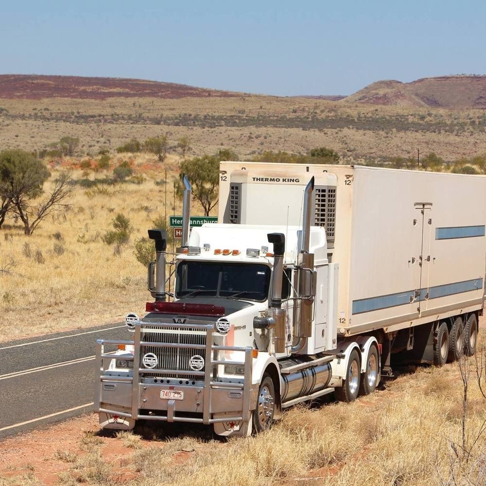 White Semi-Truck with A Refrigerated Trailer Parked — Central Australian Sidelifter Haulage in Ciccone, NT