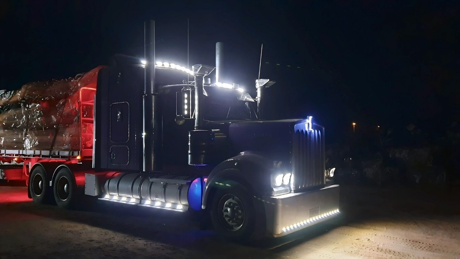 A Semi-Truck with Many Lights on At Night — NPX Solutions in Gladstone, QLD