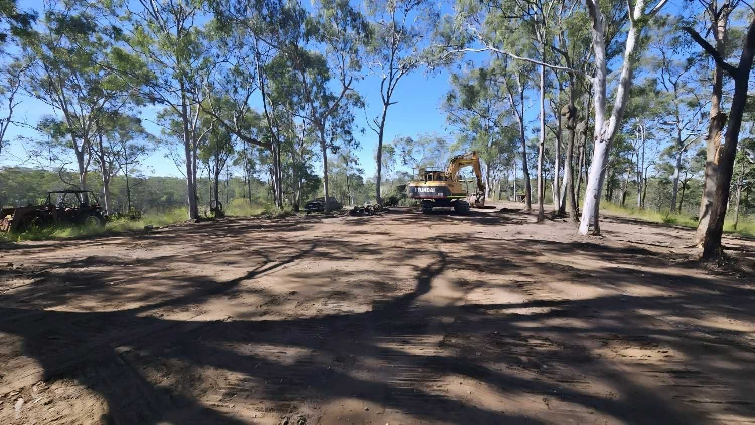 Dirt Road Winding Through Trees Under a Blue Sky, Rural Landscape — NPX Solutions In Gladstone, QLD
