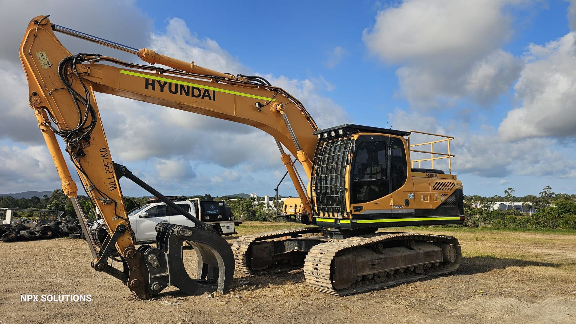 Yellow Hyundai Excavator With a Grapple Attachment — NPX Solutions In Gympie, QLD
