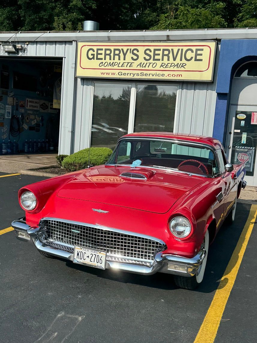 Red vintage car parked in front of 