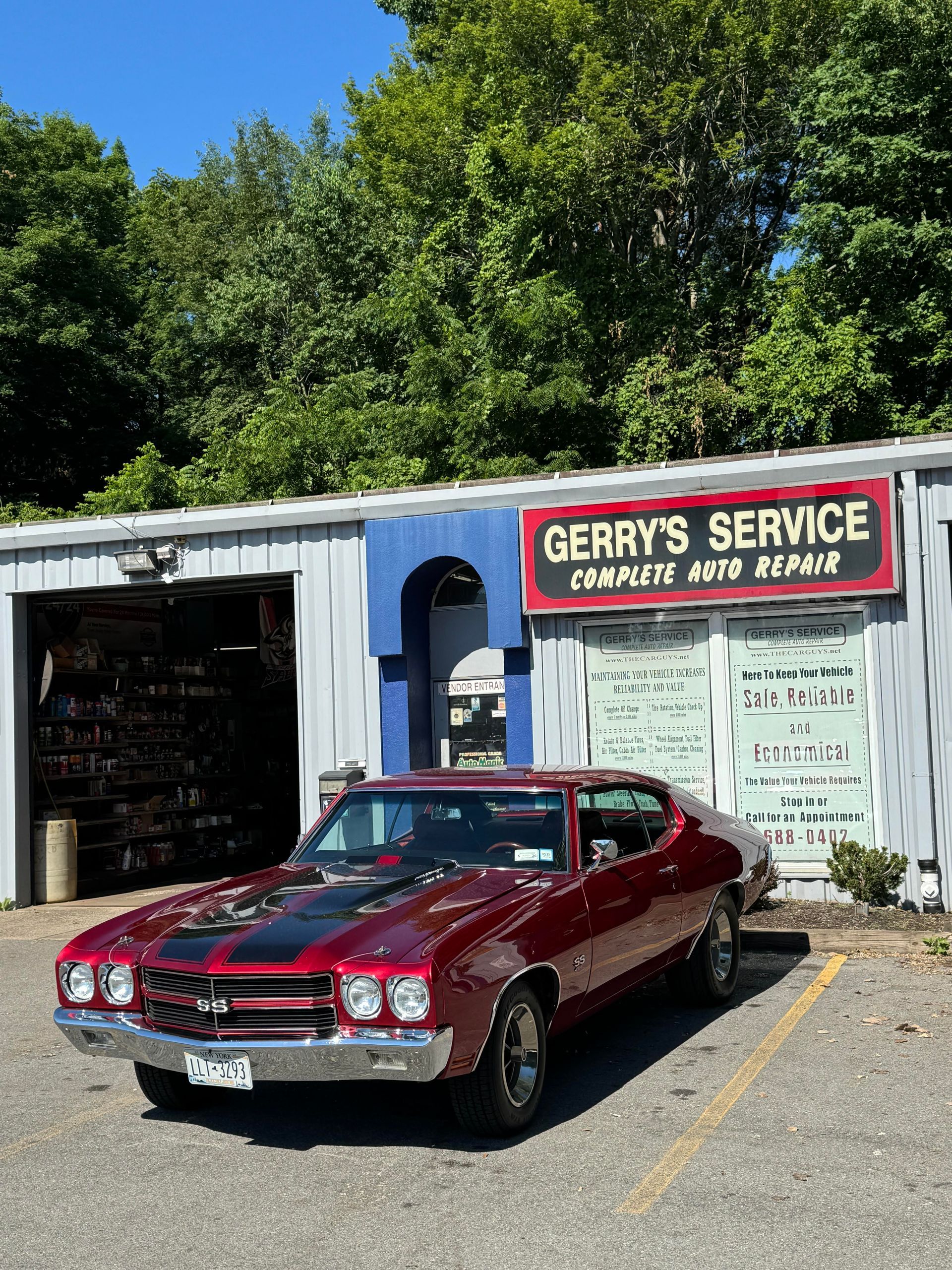 Red classic car parked in front of 