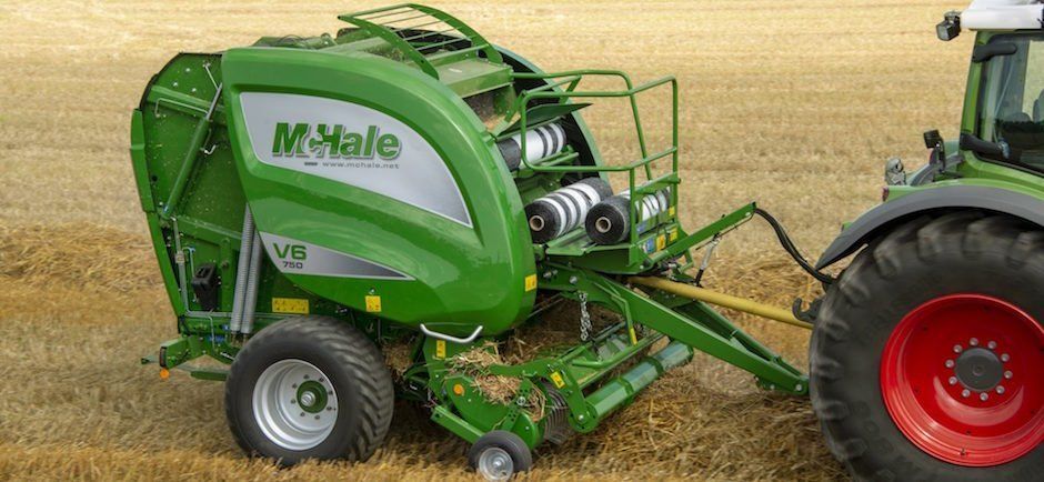A Round Baler Discharges A Fresh Wheat Bale During Harvesting — O'Brien's Machinery In Hunter Valley NSW