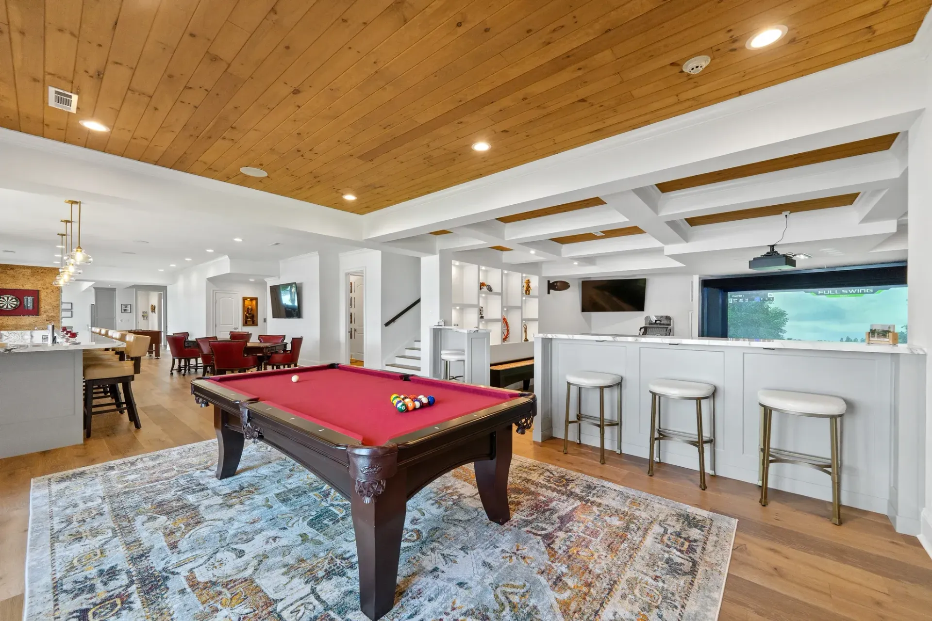 Finished basement with pool table, bar, and coffered wood ceiling in Great Waters, Lake Oconee