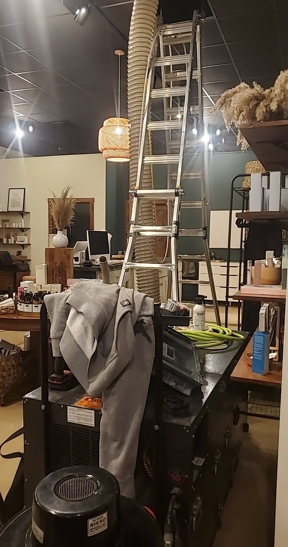 A ladder is hanging from the ceiling of a room.