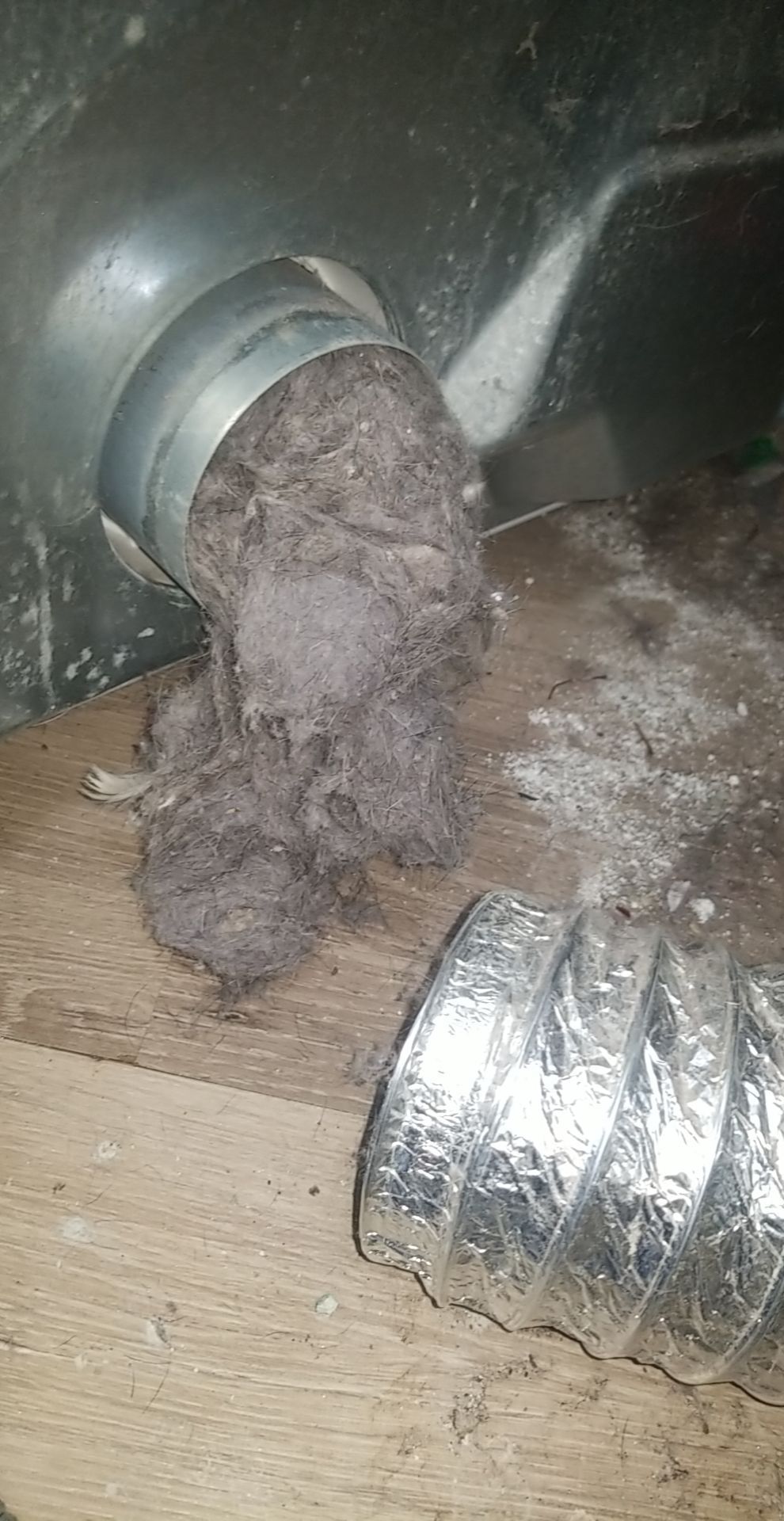 A close up of a duct with a bunch of dust coming out of it.