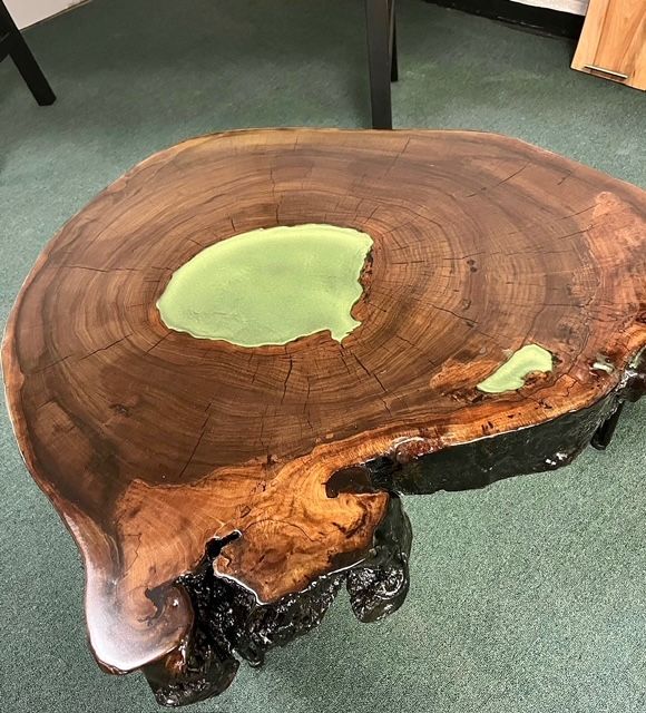 a wooden table is sitting on a carpeted floor