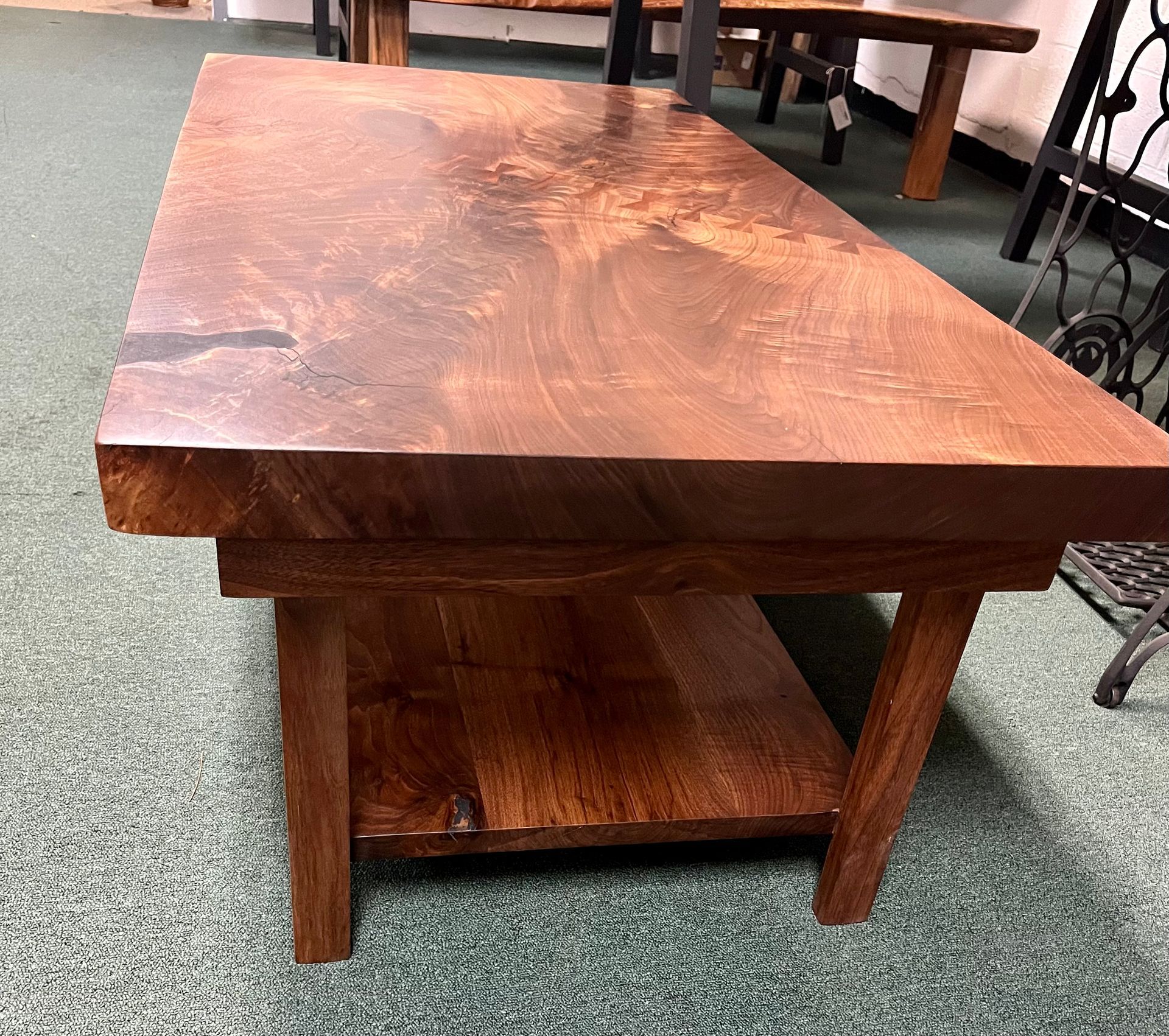 a wooden table is sitting on a carpeted floor