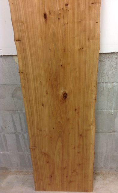 a large piece of wood against a brick wall
