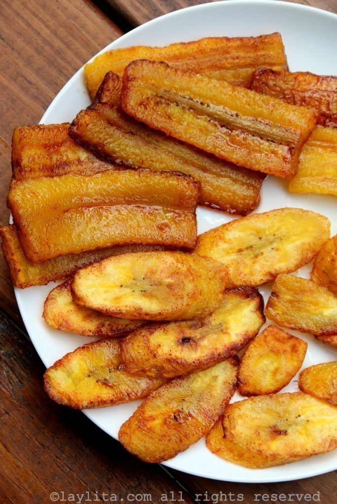 Fried plantains, golden brown and glistening, arranged on a white plate.