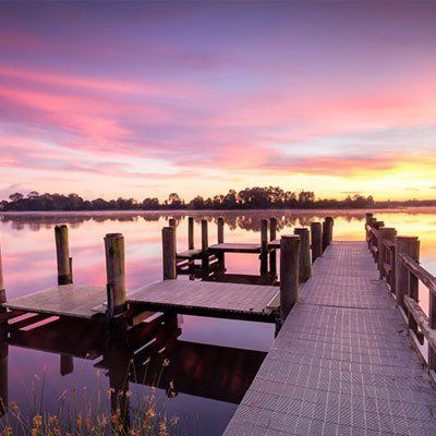 There Is A Dock In The Middle Of A Lake At Sunset  — River2Coast Concreting in Grafton, NSW