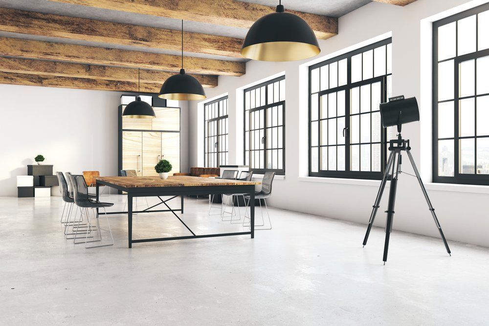 A Large Empty Room With A Table And Chairs And A Camera On A Tripod  — River2Coast Concreting in Grafton, NSW