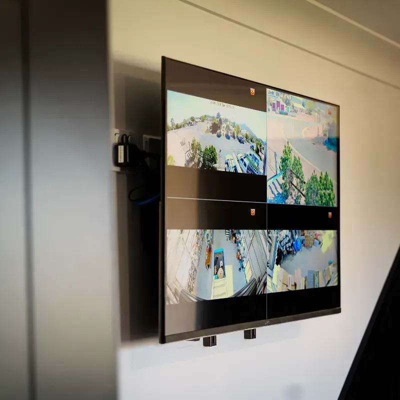 SPLIT-SCREEN SURVEILLANCE OF LIVE SECURITY CAMERA FOOTAGE ON A TELEVISION