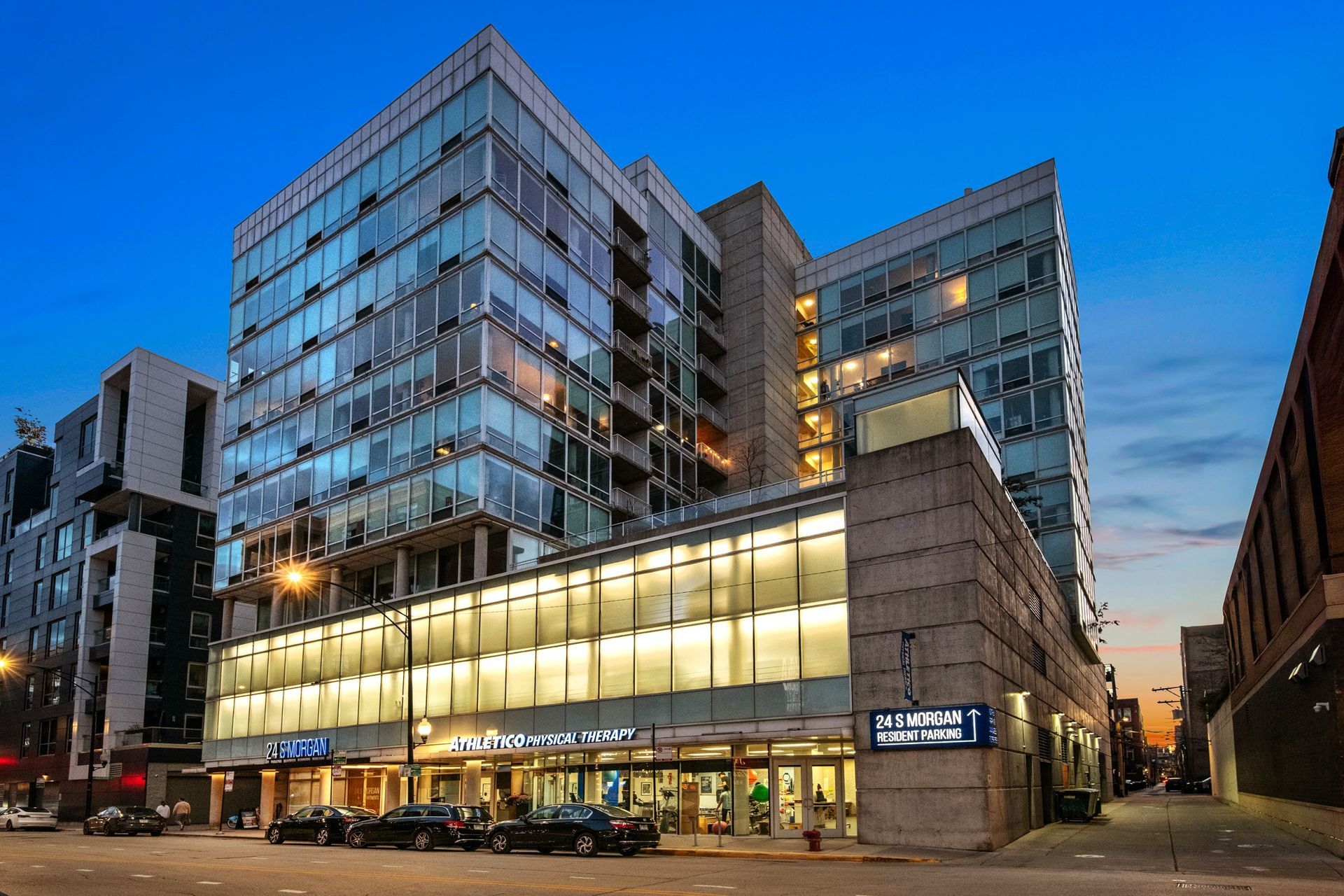 A modern building with a glass facade and a sign that reads
