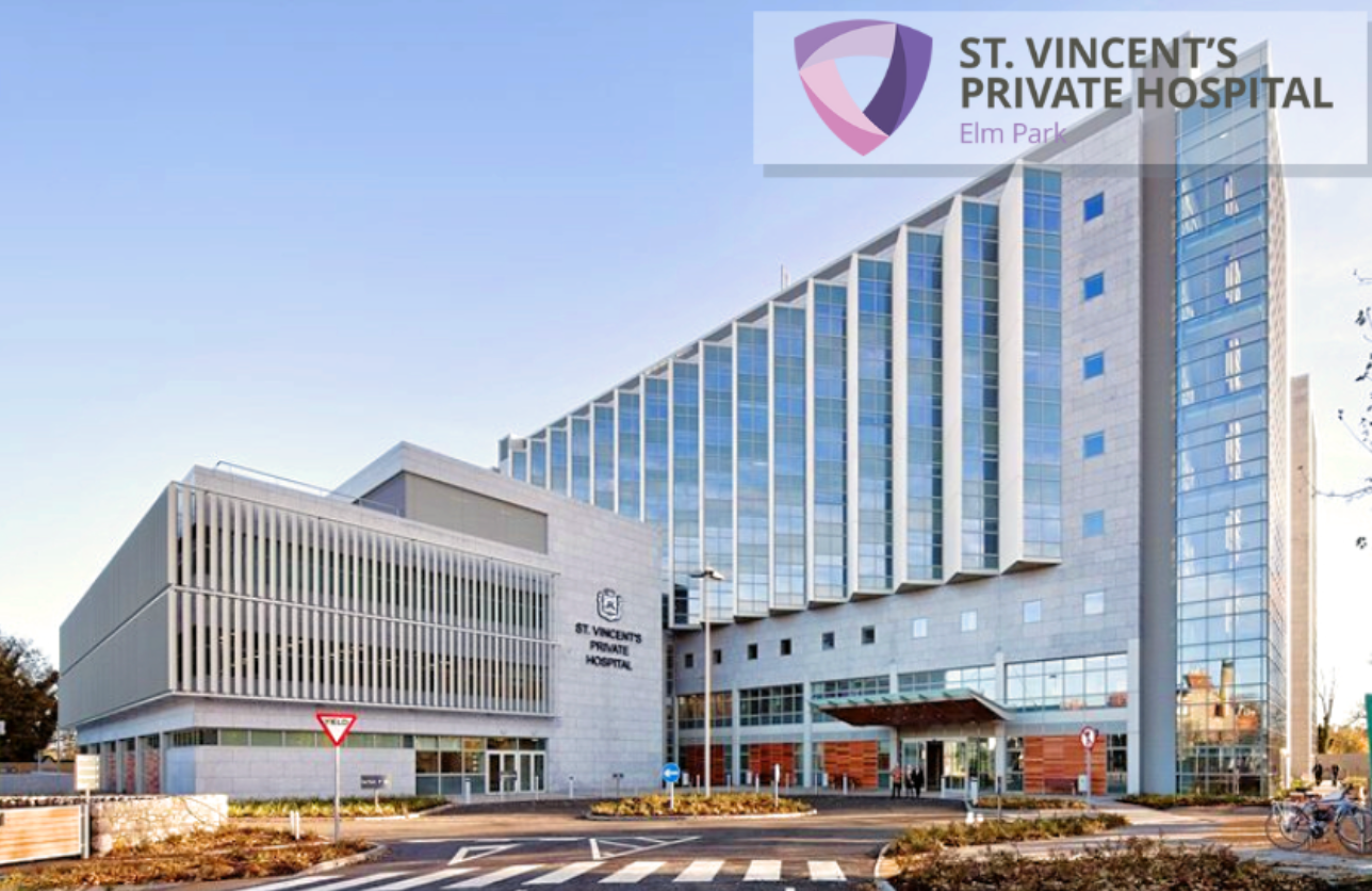 St. Vincent’s Private Hospital building exterior with glass facade and driveway at sunset
