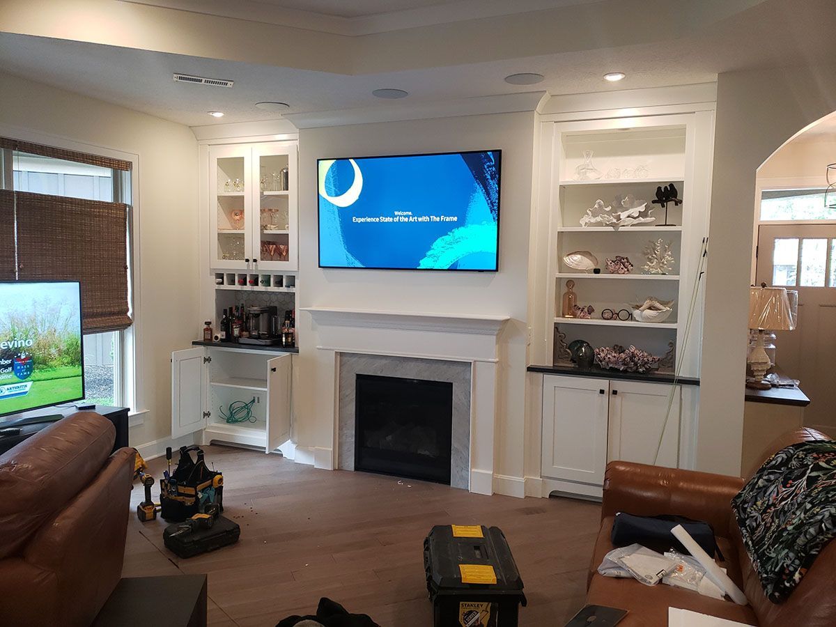 A living room with a fireplace and a flat screen tv.
