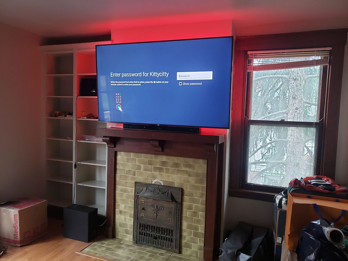 A living room with a fireplace and a flat screen tv.