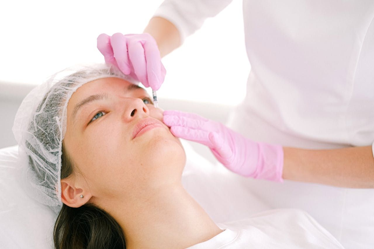 A woman is getting her face examined. — HealthPoint Mingara In Tumbi Umbi, NSW