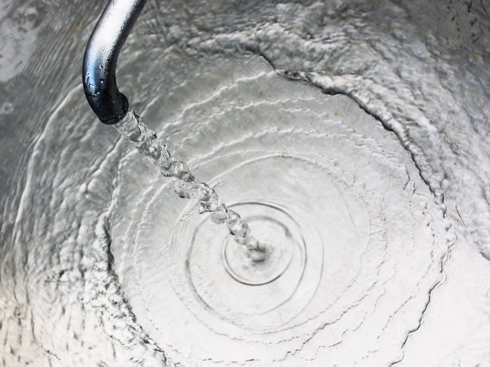 Water Pouring Into a Metal Container — Rainman Domestic Water In Childers, QLD