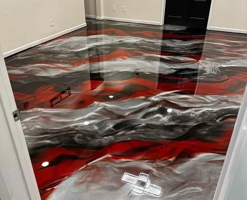 Empty room with glossy red, black, and silver abstract floor covering