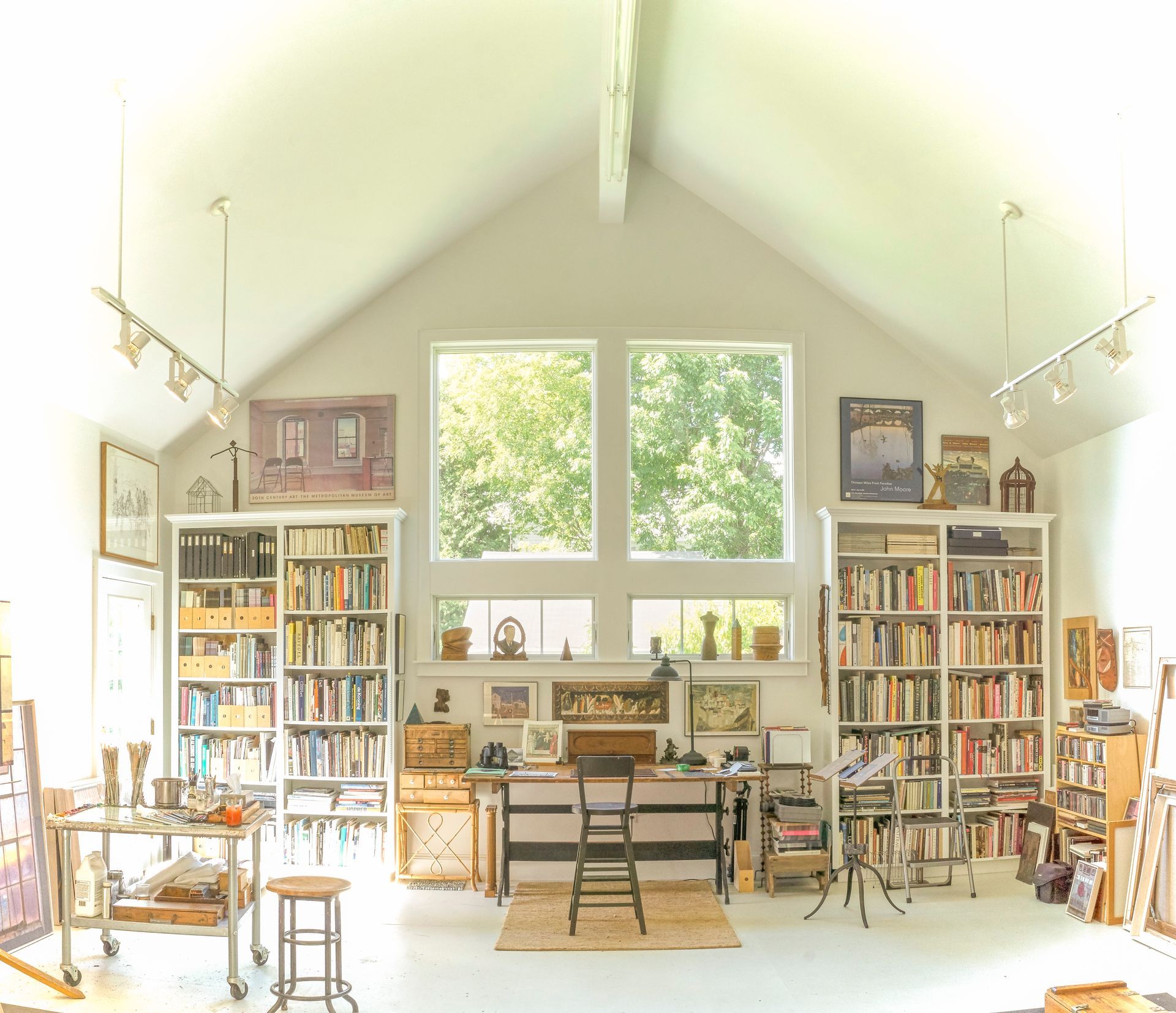 A large room with a vaulted ceiling and lots of bookshelves