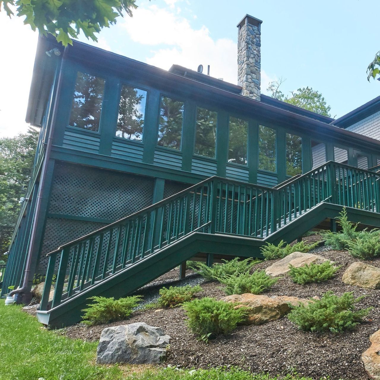 A house with green stairs leading up to it