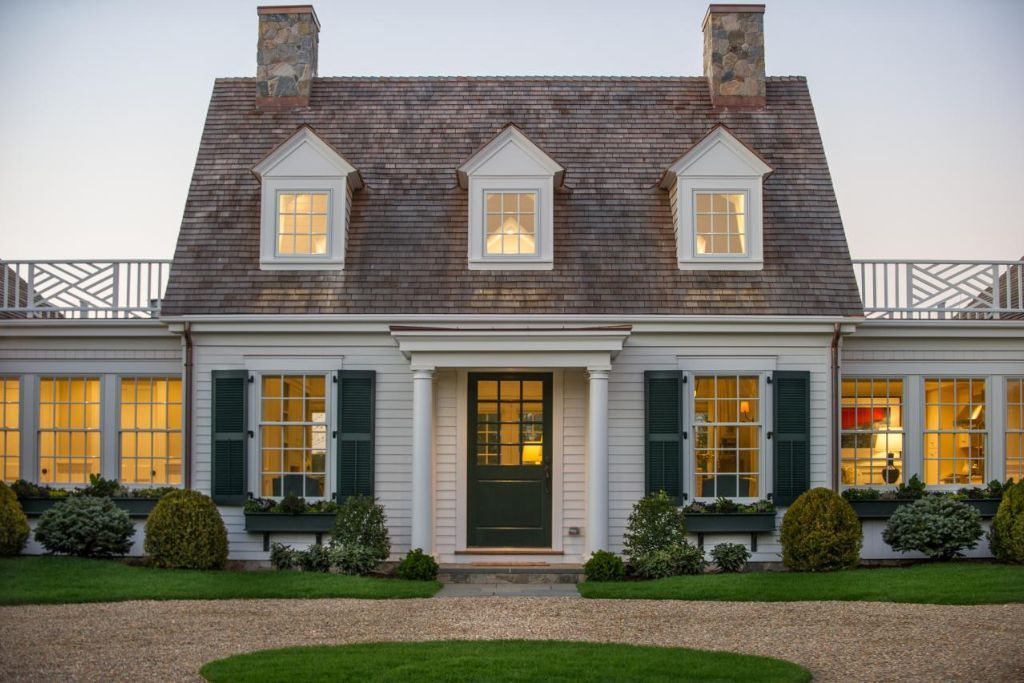 A large white house with a green door and shutters