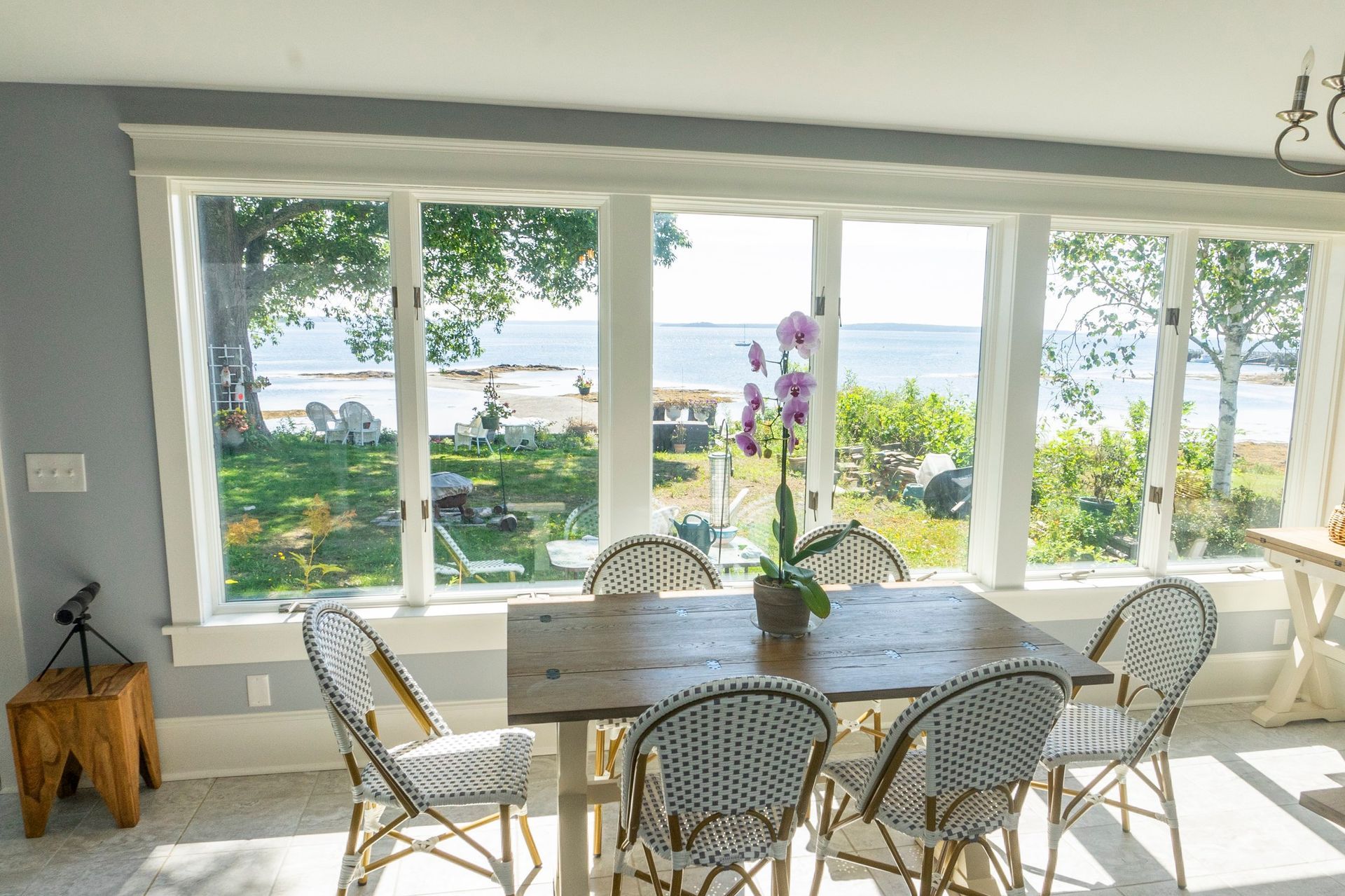 Whitecap Builders upgraded a coastal dining area with new windows in Lincolnville, Maine.