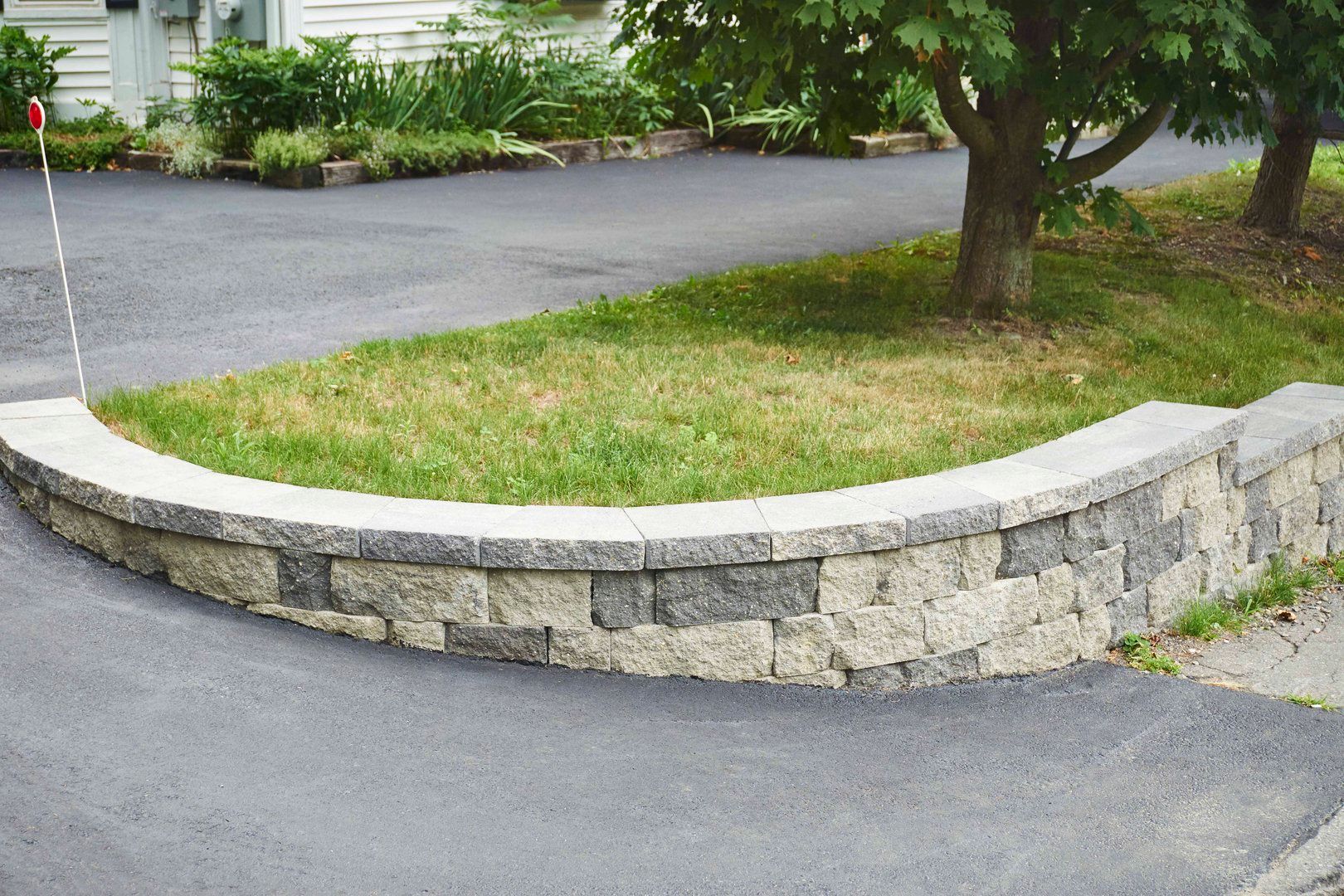 Whitecap Builders built a curved block wall for landscape support on a driveway in Belmont, Maine.