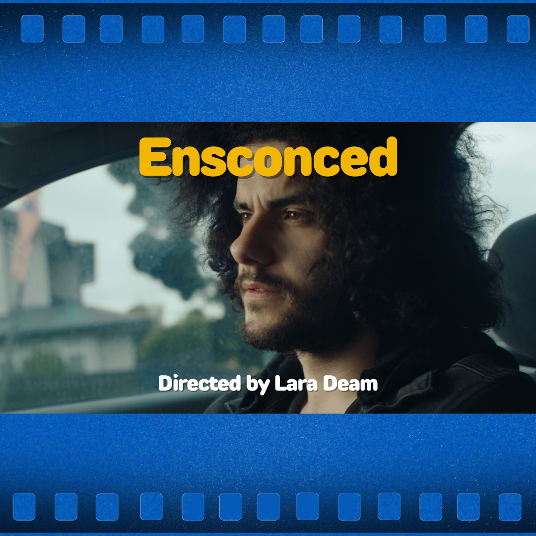Movie poster titled “Ensconced” showing a curly-haired person in a car, with “Directed by Lara Dean” text.