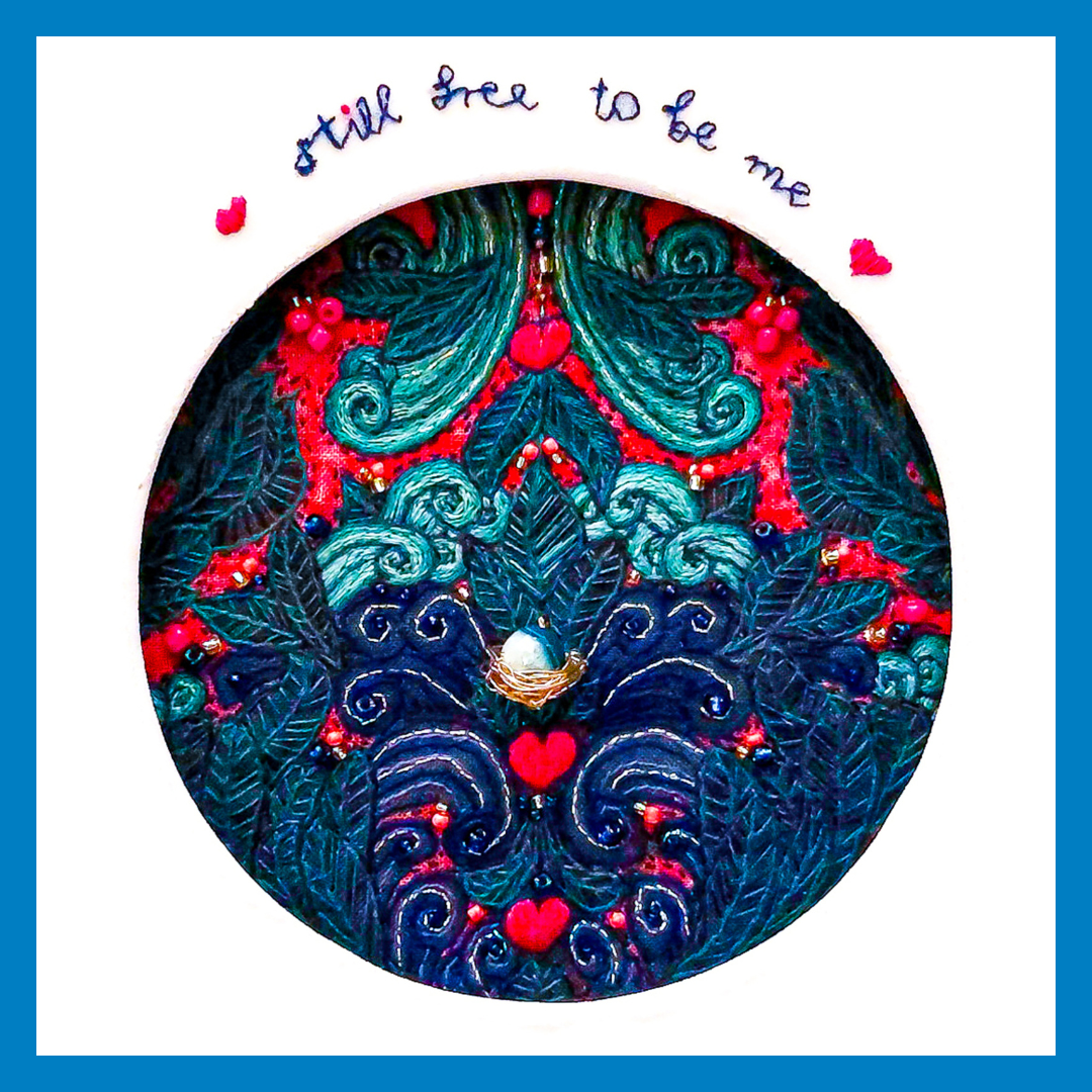 Decorative heart-shaped floral design with “Still free to be me” text and small pink hearts