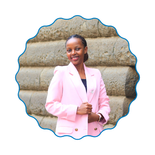 Smiling woman in a light pink blazer standing before a stone wall with a scalloped blue border