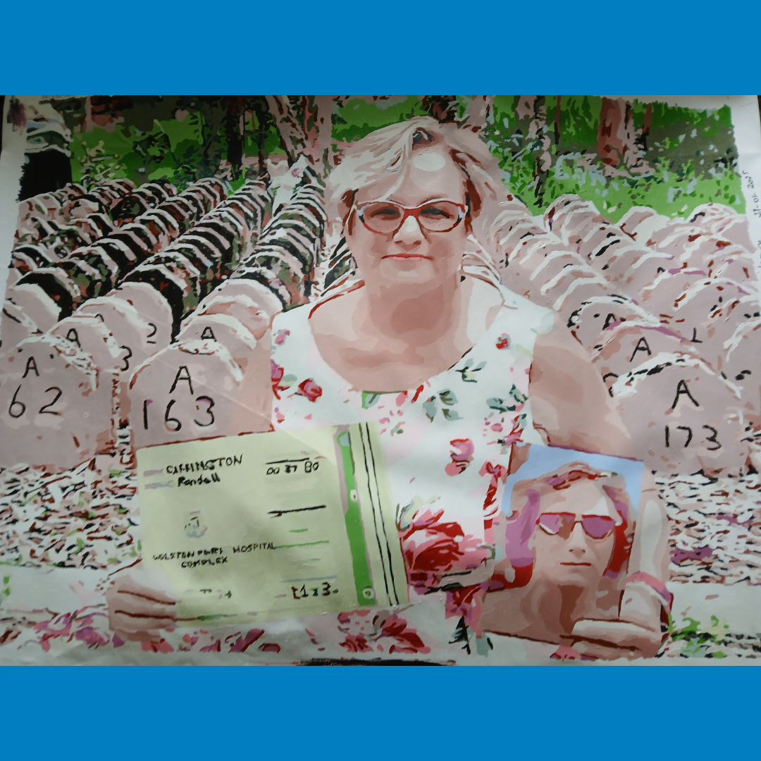 Woman holding a sign in a cemetery with rows of numbered graves and a small portrait photo in front