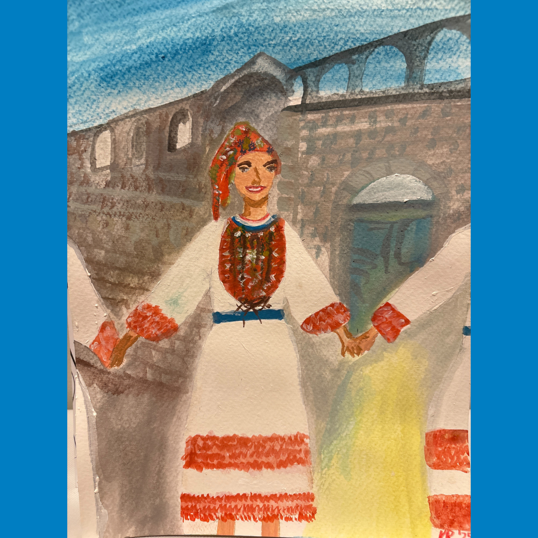 Person in a white dress with red accents stands before a stone bridge, holding fabric in both hands.