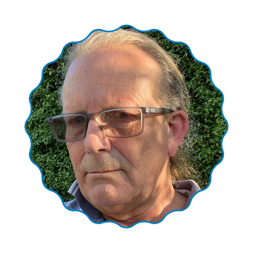 Close-up portrait of a man wearing glasses, framed by a scalloped blue border outdoors.