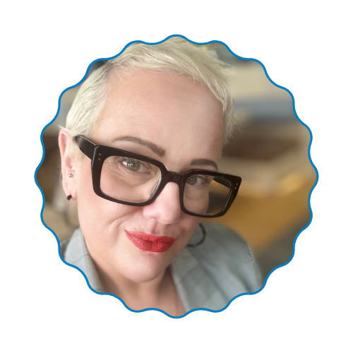 Close-up selfie of a person with black glasses and red lipstick in a scalloped blue frame